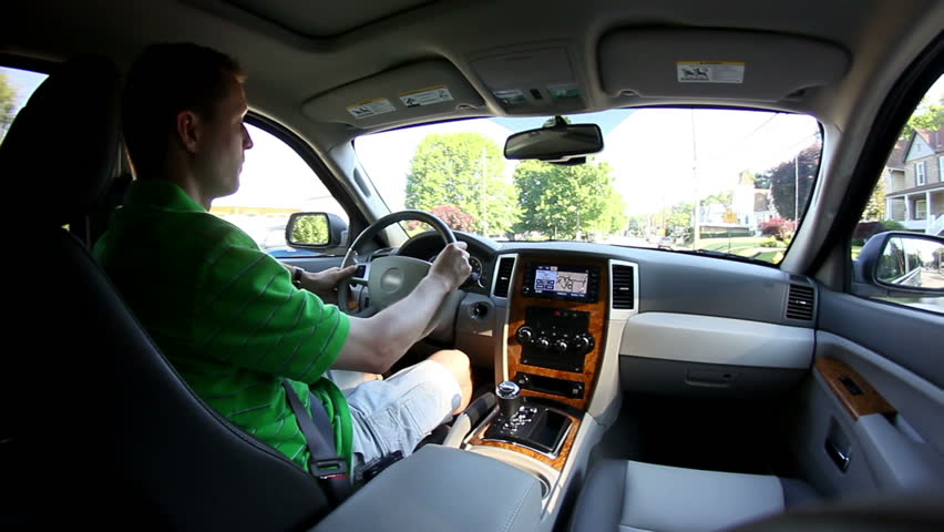 A man driving.  Fisheye lens.