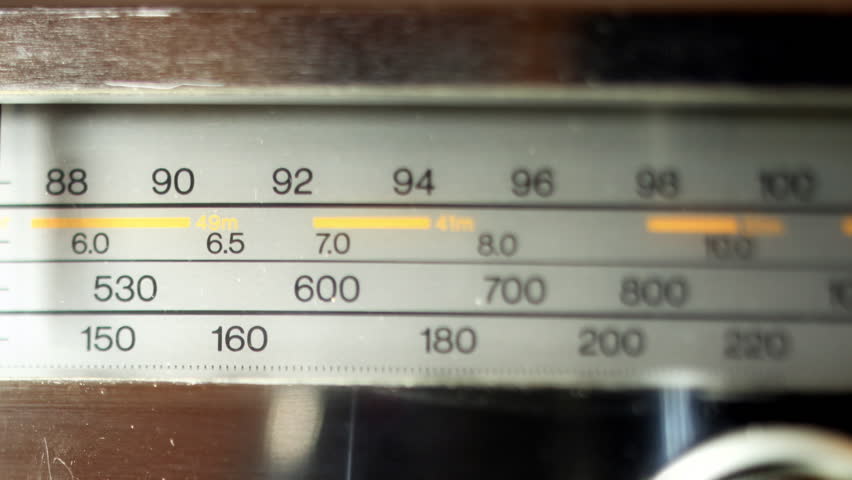 an analogue radio dial tuning in different radio frequencies
