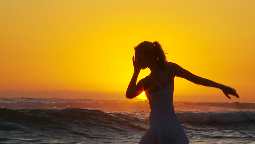 Young woman doing ballet at the beach