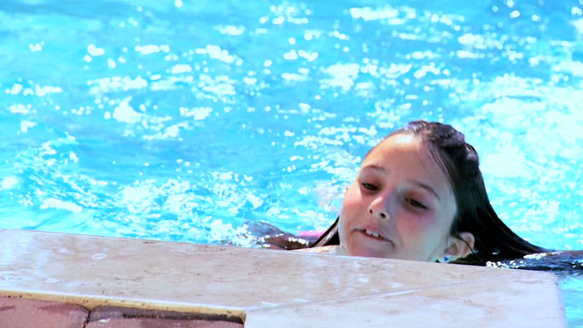 Young girl having fun in her family swimming pool 60 FPS