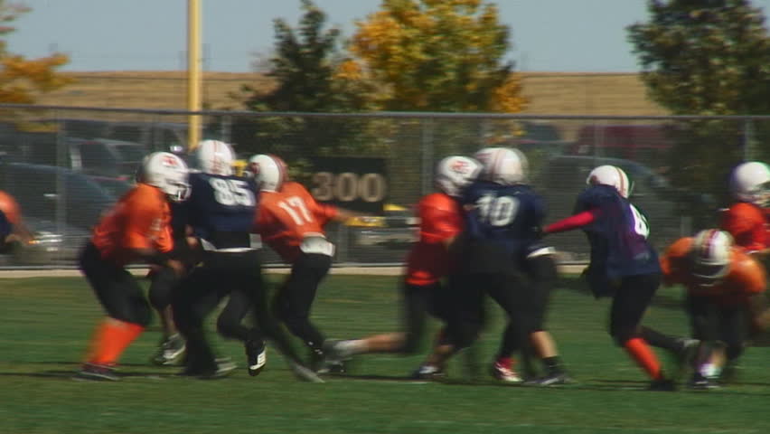 Youth football teams enjoy full contact game-running play; HD, audio 