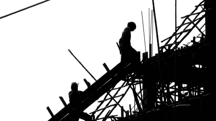 Construction site and workers silhouette