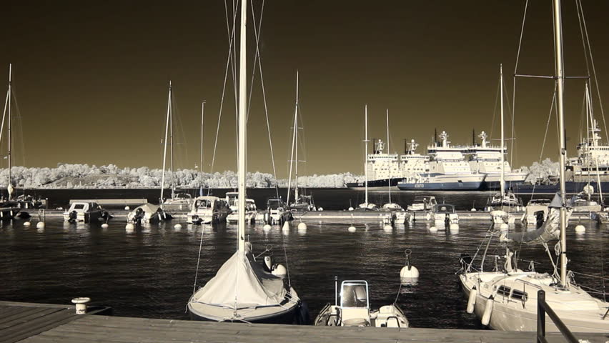 HELSINKI - JULY 4: Infrared Finland - motorboats, yachts and big commercial ships in a harbor July 4, 2010 in Helsinki, Finland. 