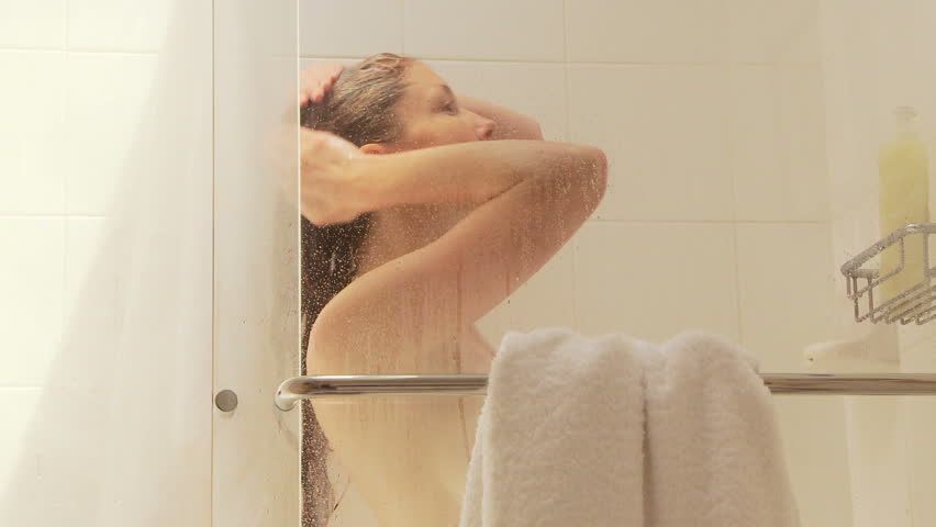 Woman washing hair in shower