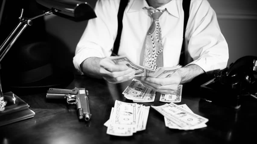 A man sitting counting money with a pistol placed carefully within reach answers the telephone. Film Noir, Vintage  look