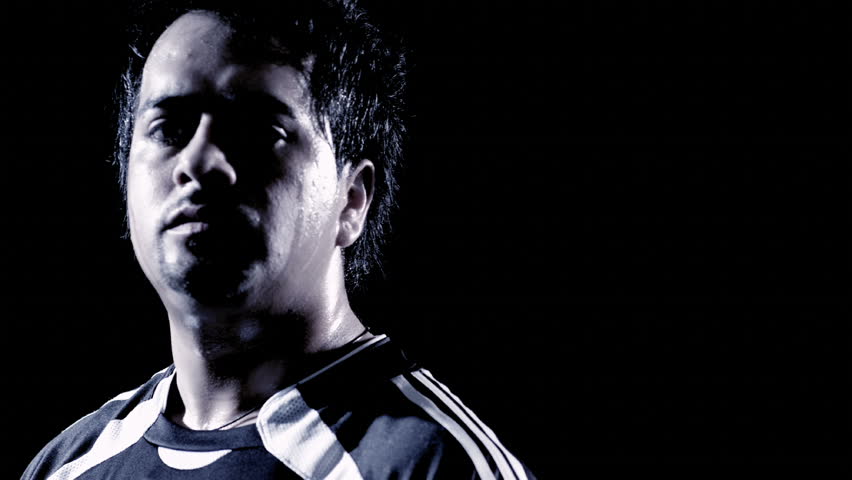 A Latino man juggles a soccer ball