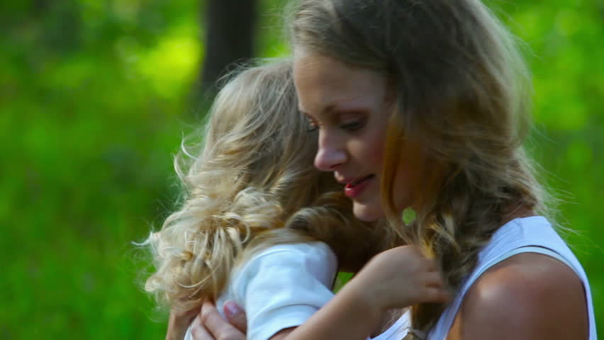 Young mother hugging her crying daughter