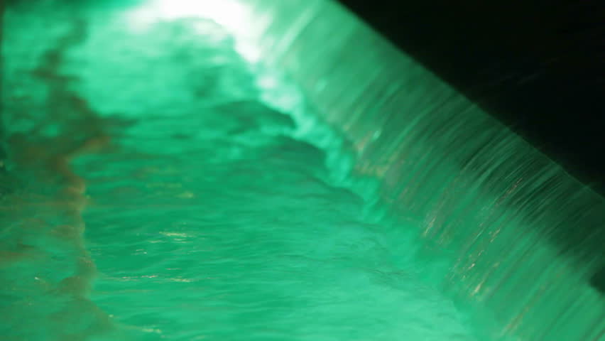 Waterfall with green water. A small waterfall and a torrent of water. Green light water.