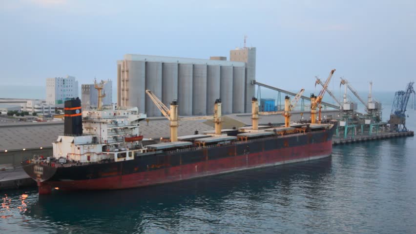 camera moving past by barge stopped in seaport in Abu Dhabi, UAE