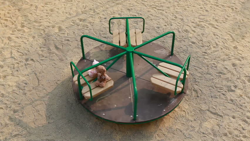 Two teddy bears on carousel  