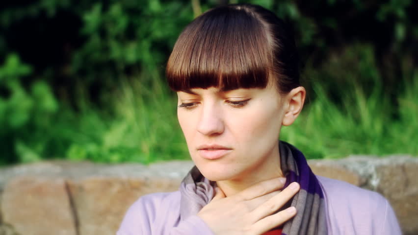 Sick woman coughing, outdoors