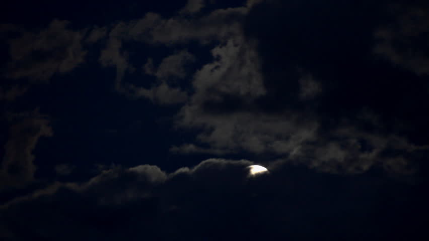 timelapse with moon moving between clouds