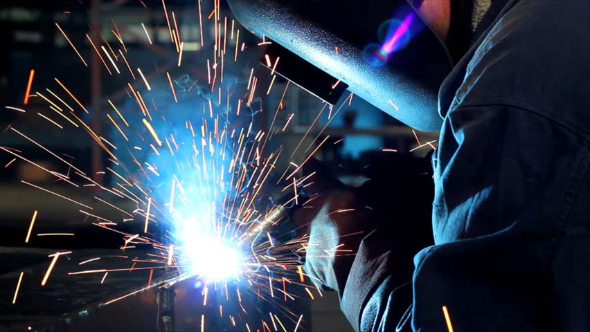 Welder at work in factory