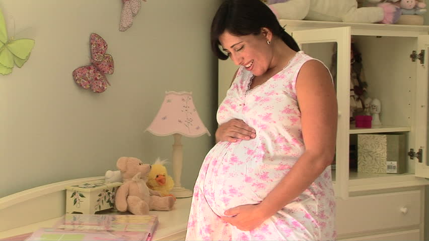 Close up of pregnant woman holding belly