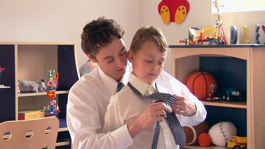 Father helping his son with tie