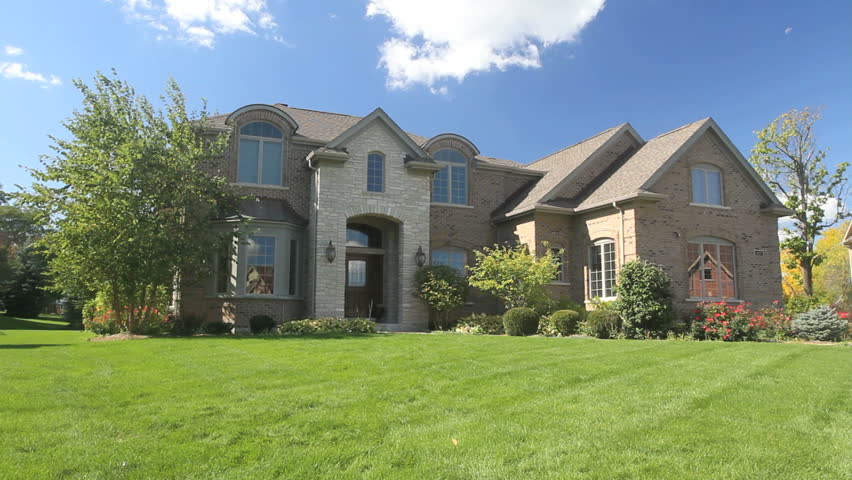 A boy runs into the arms of his dad in front of their luxury home 