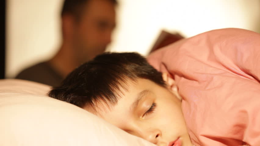 boy asleep, dreaming in his bed 