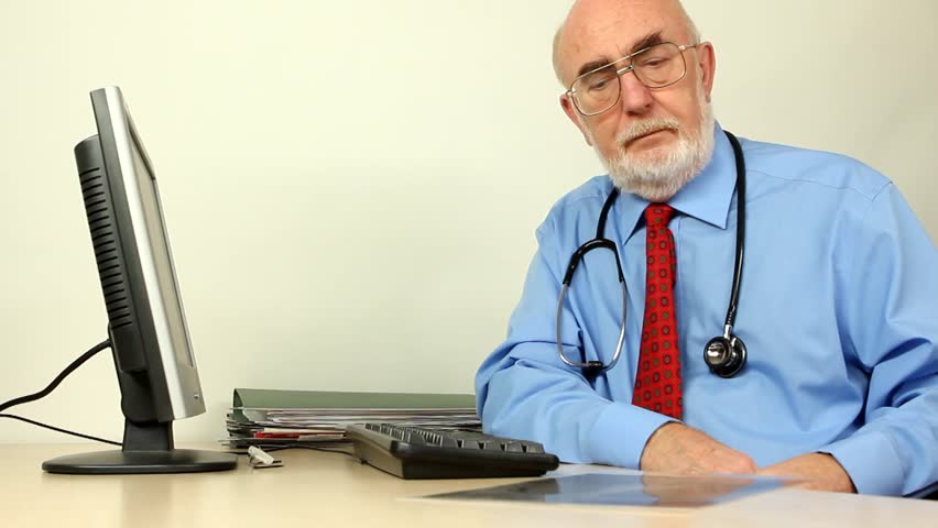 Doctor at his desk looking at an xray