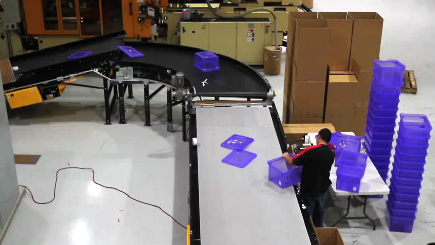 A time lapse of a factory assembly line with workers. 