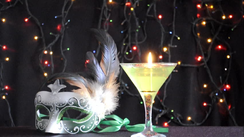 Green fancy mask with candle and blinking lights on black