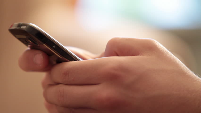 young man types the text on mobile.  