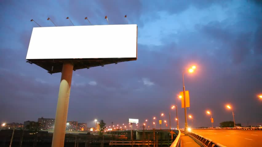 night bridge in city with moving cars and empty billboard