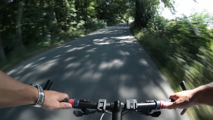 biking (riding a bike on a lovely sunny day;  motion blurred footage shot from a moving bike)