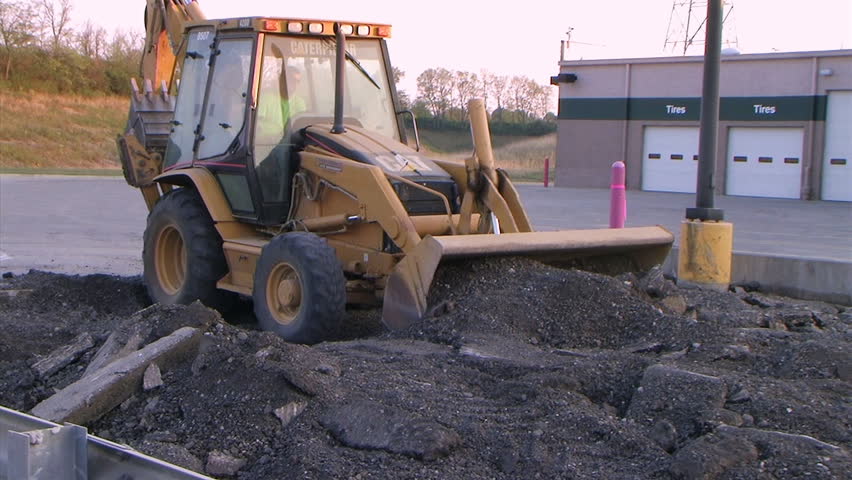 Backhoe Loader Pushing Pavement - audio from external microphone.
