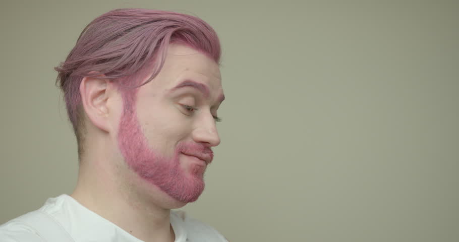 Side Portrait Of The Man With Pink Hair And Beard Drinking Light Green