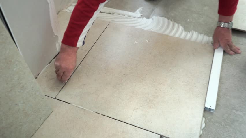 Master Puts And Glues Tile Floor Tiles Laying Of Adhesive Master Puts And Glues Tile Floor Tiles Laying Of Adhesive
