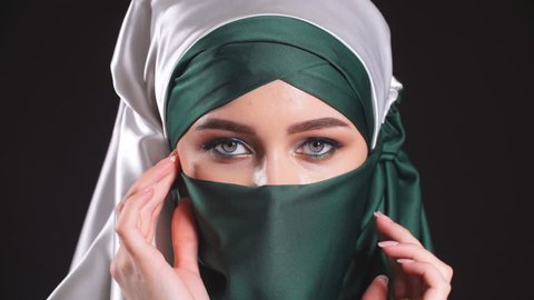 Portrait of an arabic young woman with her beautiful eyes in traditional islamic cloth niqab.