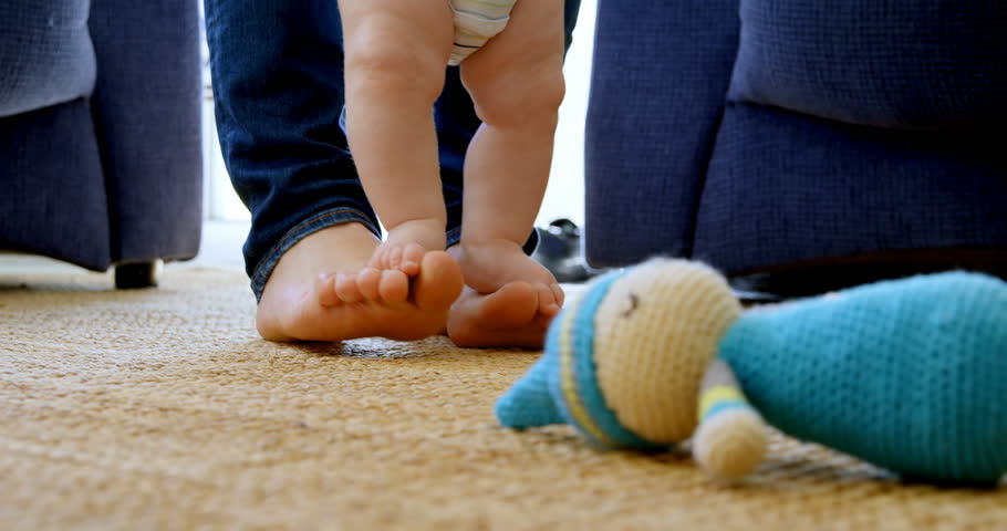 4k00 12close Up Of Father Helping His Baby Boy To Walk In Living Room