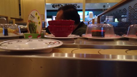 Kuching, Malaysia - April 2019. Variety Of Sushis On Conveyor Belt At Sushi  King Restaurant. Sushi King Is The Largest Japanese Restaurant Chain In  Malaysia