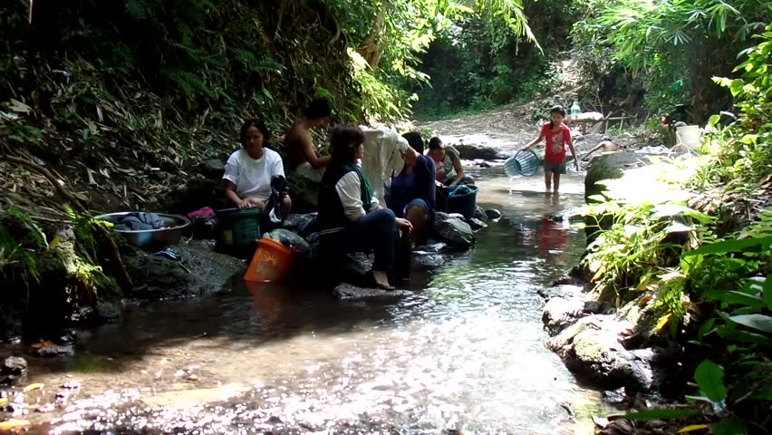 CIRCA 2010s - Belize - Women Wash Clothes In A River In A Third World ...