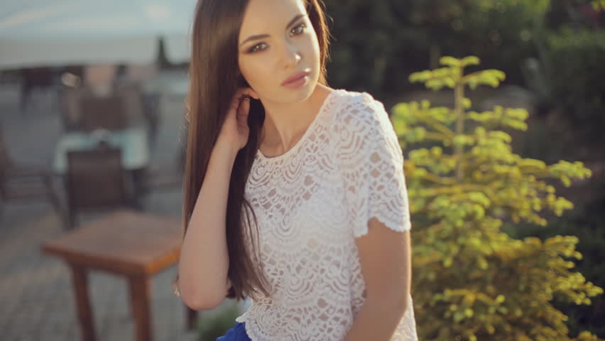 Sexy Brunette In A Long Blue Skirt And A Lace Tank Top Sitting On Rock In A Park Under The Soft Light Sexy Brunette In A Long Blue Skirt And A Lace Tank Top Sitting On Rock In A Park Under The Soft Light