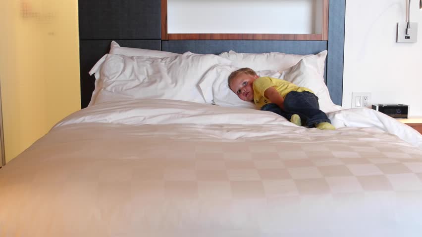 A Toddler Boy Lying On Stock Footage 100 Royalty Free A Toddler Boy Lying On Big Comfortable King Size Bed In Hotel Room