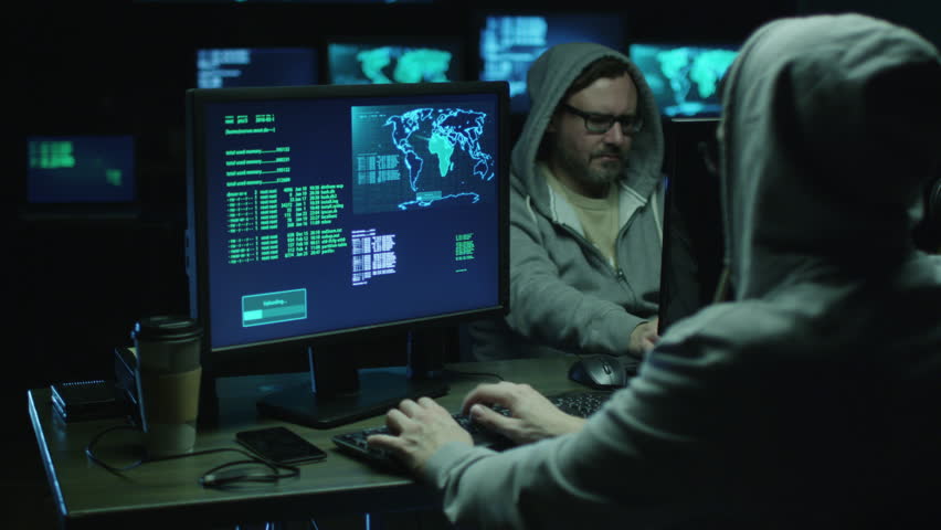 Two IT Programmers Are Working On Computer In A Dark Two IT Programmers Are Working On Computer In A Dark