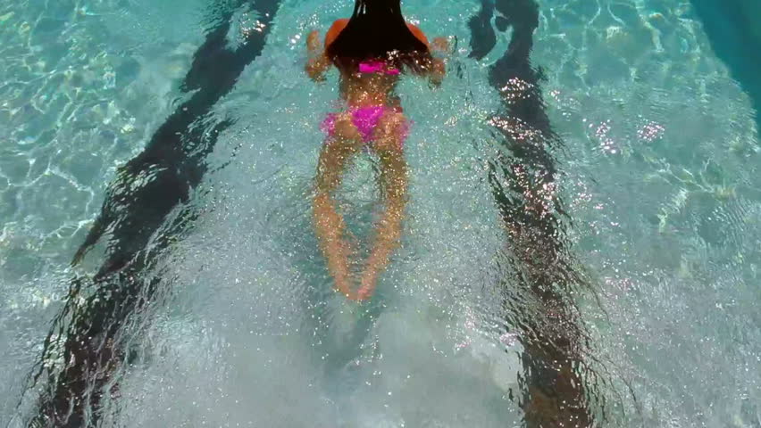 Beautiful Woman In A Pink Bikini Diving In And Swimming 
