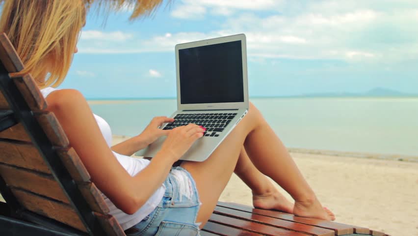 Hd00 20young Woman Sitting At The Sunbed With A Laptop In Front Of