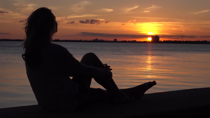 Lonely Woman Sitting On The Pier. Dreaming And Enjoying Sunset ...