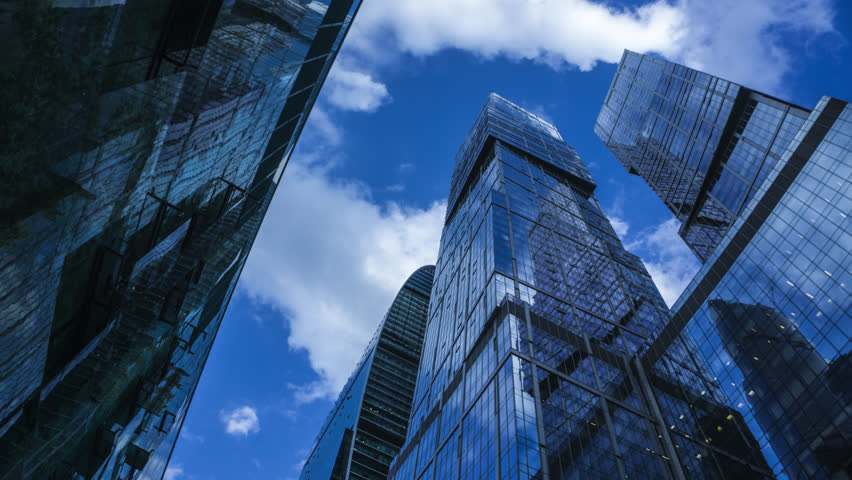 Stock Video Of Modern Reflective Skyscrapers Against Cloudy Sky