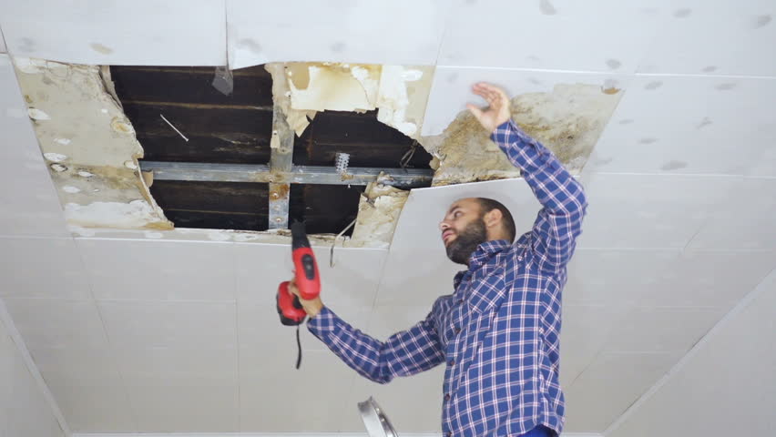 Man Repairing Collapsed Ceiling Ceiling Panels Damaged Huge Hole
