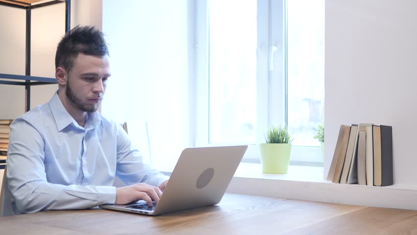 Young Man Working On Laptop Video de stock (totalmente libre de ...