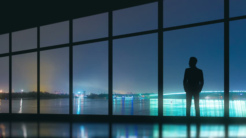 The Man Stand Near The Panoramic Window On The Night City Background ...