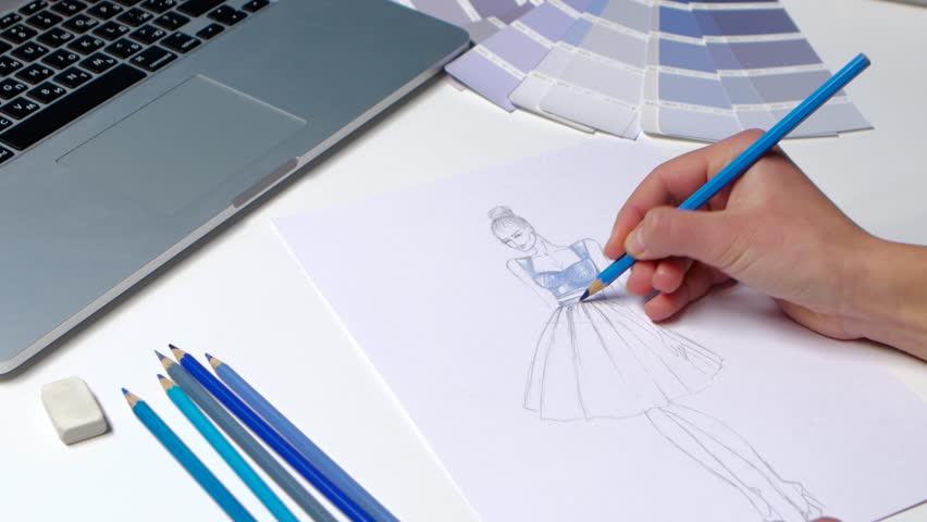 Designer With A Pencil Sketch Stock Footage Video 100 Royalty Free Designer With A Pencil Sketch Decorates Dresses In Blue Close Up