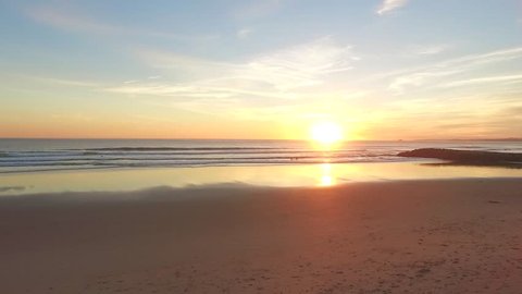 Aerial video in motion of sunset in the Atlantic Ocean in Costa da Caparica, Lisbon, Portugal