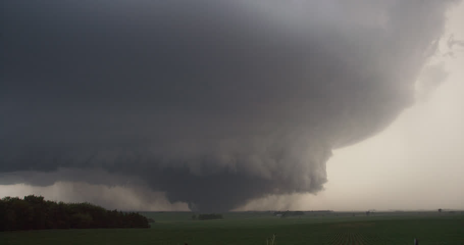 A Massive Wedge-shaped Tornado Looms Above Nebraska Farmland Stock 