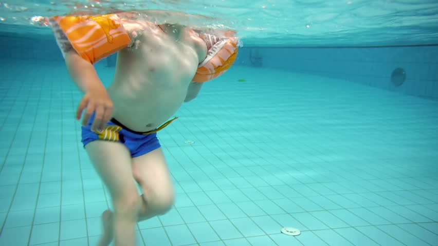 Children Holding Hands Jumping Into The Water While Camera Submerges