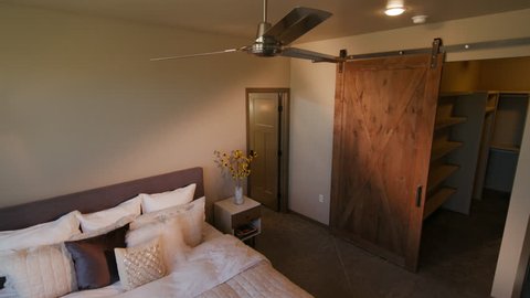 Master Bedroom Lowering With Barn Door Walk In Closet Lowering Shot Of A Modern Master Bedroom With A Large Walk In Closet