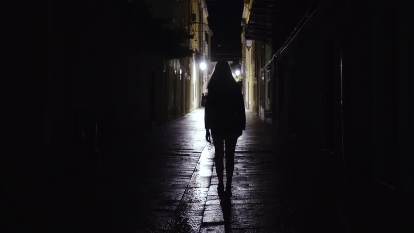 Female Person Walk Across A Garden In Dark 4K. Artificial Light At ...